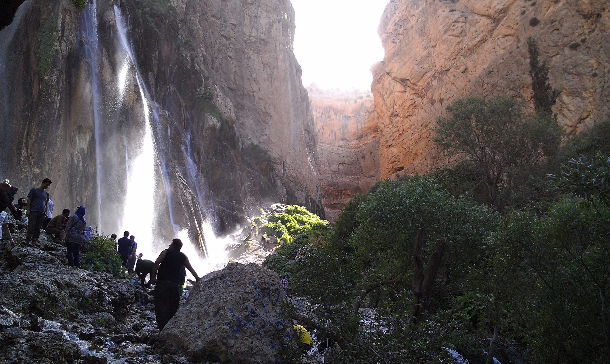 People by waterfalls in the mountains