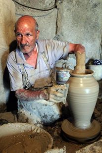 An old man making pottery