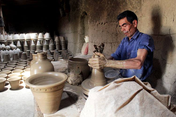 An old man making pottery