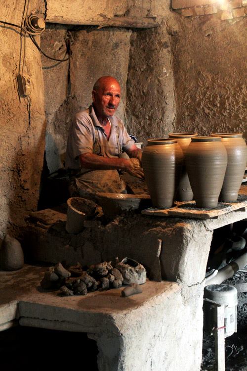 An old man making pottery